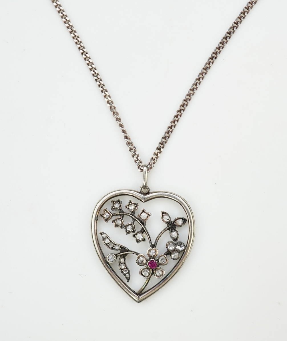 A diamond pendant, designed as a spray of flowers in a heart-shaped frame, set with rose-cut diamonds and a circular-cut ruby, to a later silver chain, pendant 3.1cm, chain length 44cm
